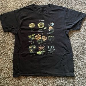 Cute tee with different types of flowers on it.